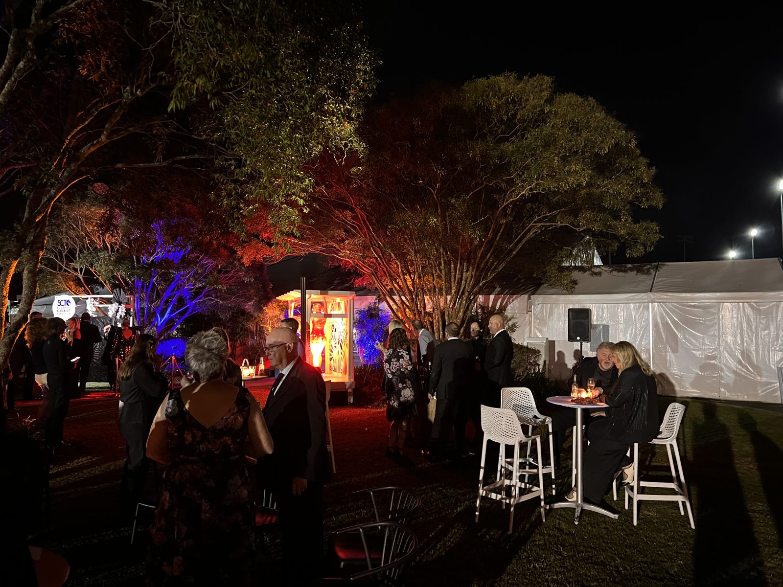 Guests at a corporate evening on the lawn at Corbould Park Racecourse