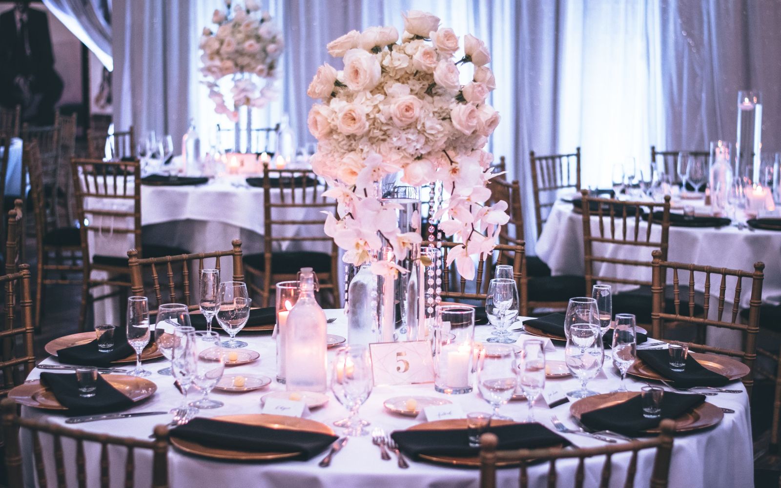 Illustrative image: Round tables set for a formal dinner