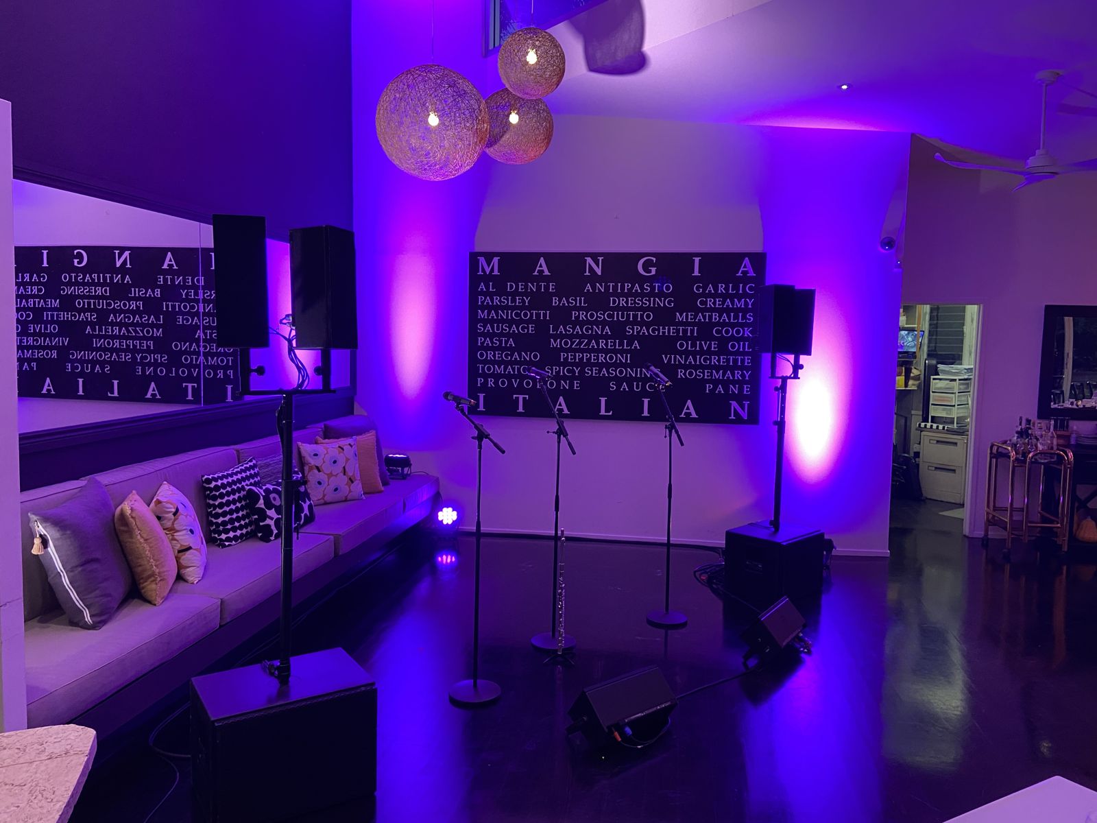 Stage and uplighting set for a dinner show at Noosa Waterfront Restaurant