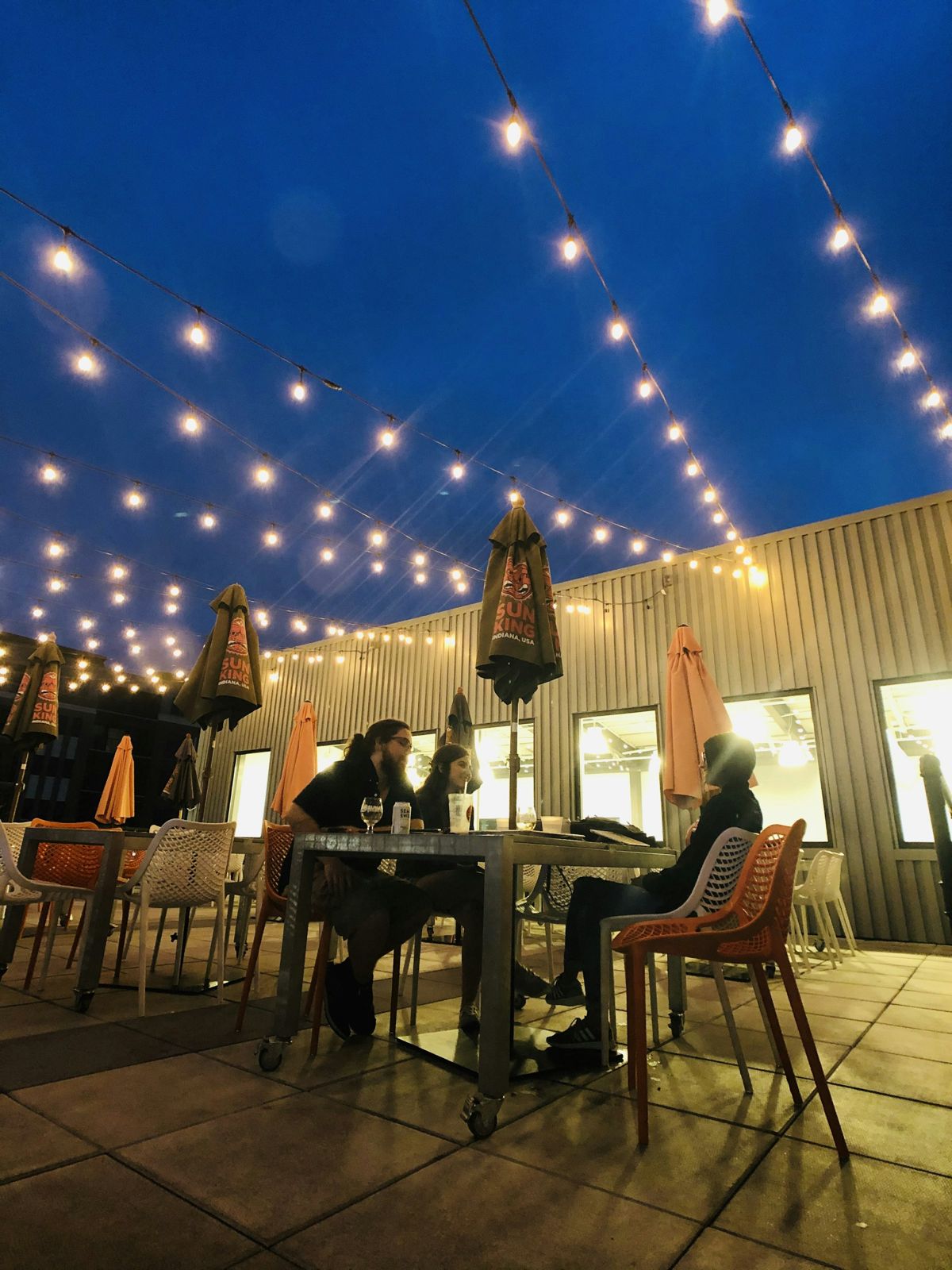 Illustrative image: Outdoor dining under festoon lights at night