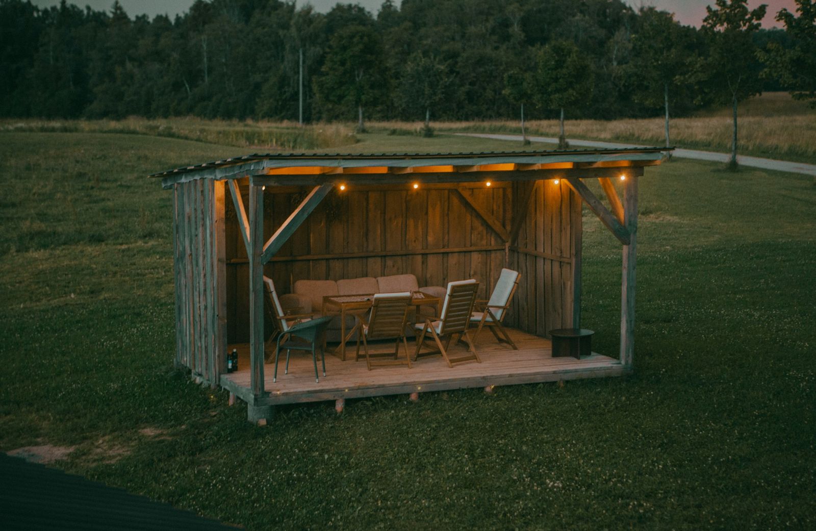 Illustrative image: Outdoor party shelter lit with string lights at dusk