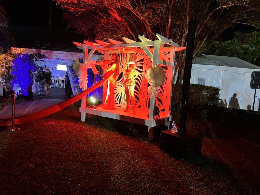 Pergola lit red at night for an activation at Corbould Park