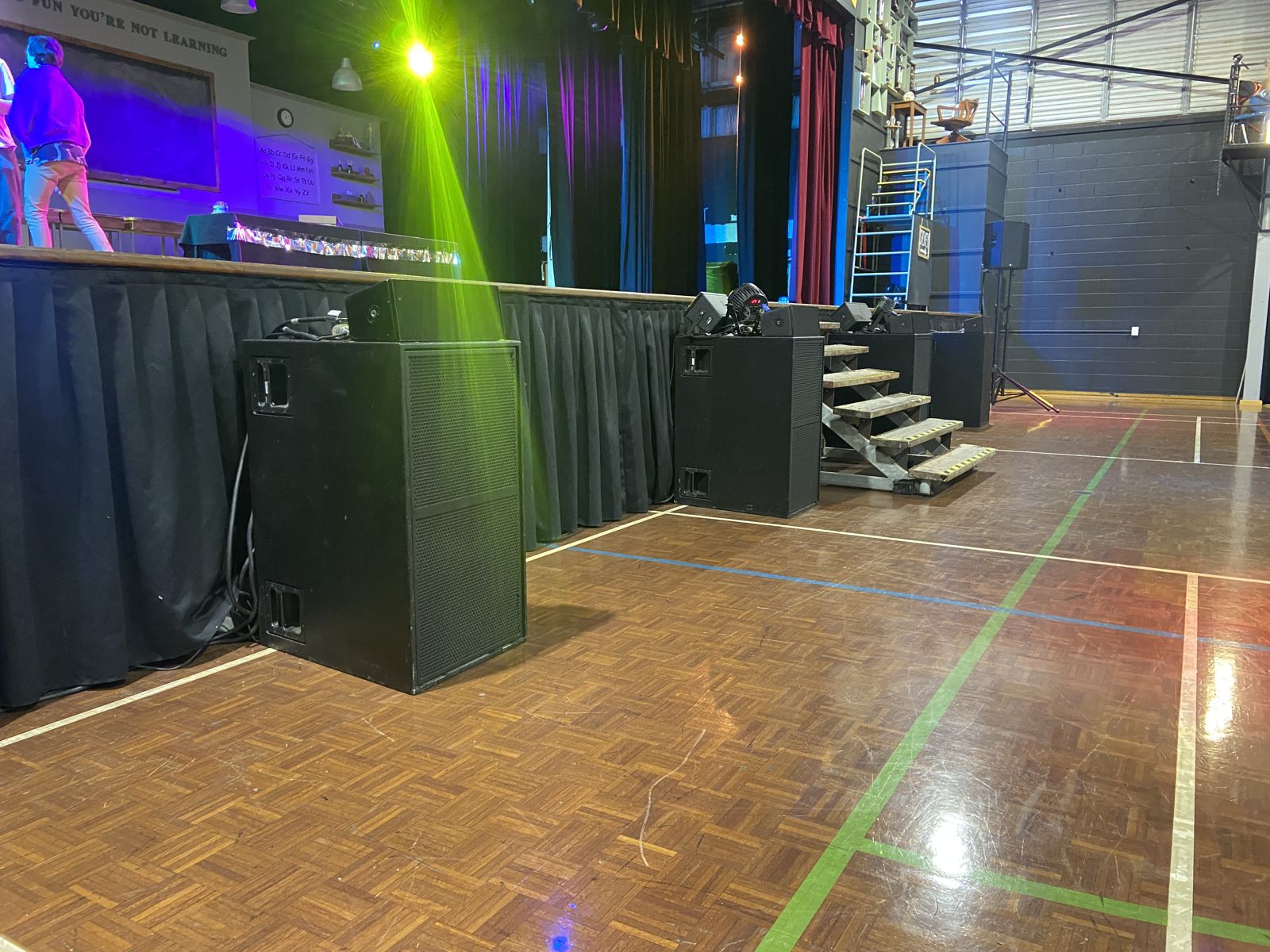 Subwoofers set in front of the stage for a school production